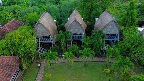 an aerial view of a house with palm trees at Abian Huts Dream Beach Lembongan in Nusa Lembongan