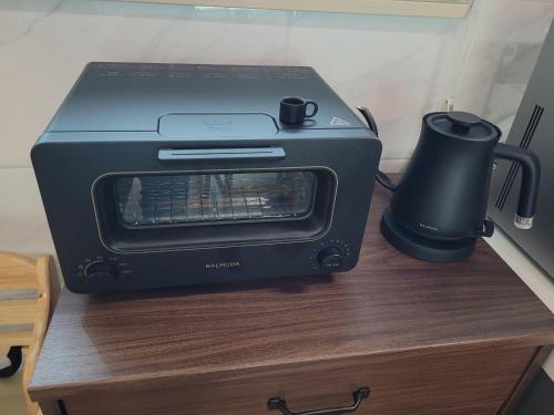 a toaster oven sitting on top of a table at Joohane Jejudo House in Jeju