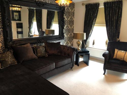 a living room with a couch and a mirror at Cozy Sheffield Guest Room with Shared Facilities in Sheffield