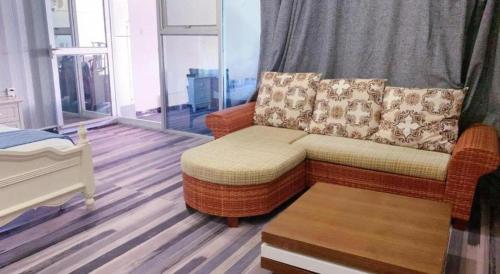 a living room with a couch and a table at Crystal Palace Hotel in Port Vila