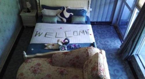a bedroom with two beds with the words welcome at Crystal Palace Hotel in Port Vila