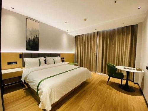 Ένα ή περισσότερα κρεβάτια σε δωμάτιο στο GreenTree Inn Hebei Langfang Bazhou Railway Station West Yingbin Road Express Hotel