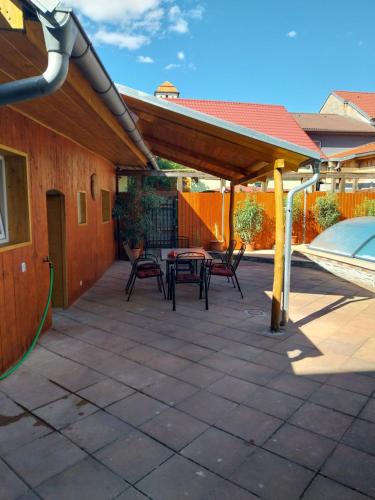 a patio with tables and chairs under a roof at Penzion u Šmídů Náměstí in Jaroslavice
