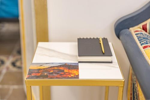 a table with a notebook on it next to a chair at Montecelio Golden House in Guidonia
