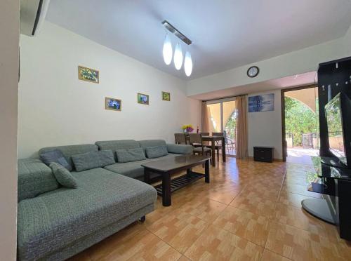 a living room with a couch and a table at Beach Town House, Green Garden, 2 bedrooms, 2 bathrooms in Paphos