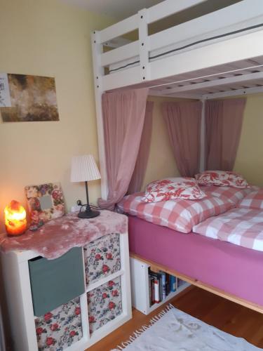 a bedroom with a bunk bed and a table with a lamp at Dominique in Hohenfels
