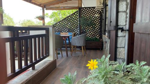 a patio with a table and chairs on a balcony at Thea Thalassa in Vourvourou