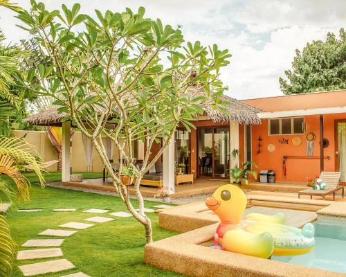 a house with a rubber duck in the yard at Halamanan Residences in Panglao