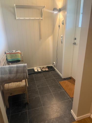 a hallway with a table and a chair and a door at Stranda Apartment in Senja