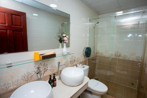 a bathroom with a toilet and a sink and a shower at Anh Hotel in Ho Chi Minh City