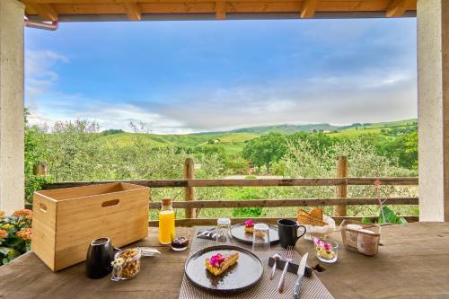 a table with a plate of food and a view at Agriturismo Ca' Belluccio in Santa Maria del Piano
