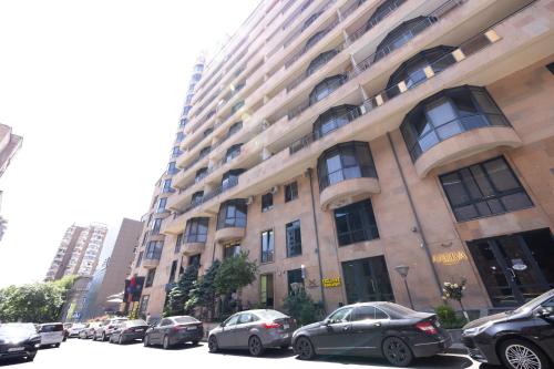 a large building with cars parked in front of it at Lux Apartment On Amiryan Street, 2 Bedrooms, 2 Bathrooms, Open Balcony in Yerevan