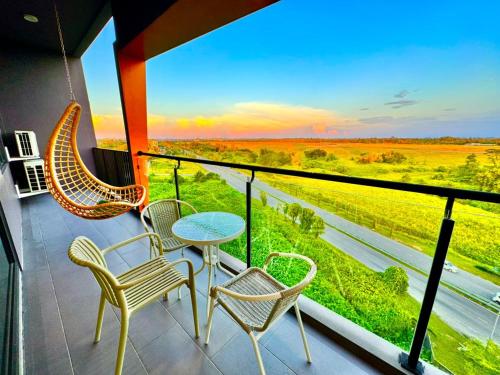 a balcony with chairs and a table and a view at 24'HR CHECK IN H'FLOOR SARADISE ECHELON KUCHING LUXURY BALCONY CONDO FACING AIRPORT 3R2B-2Cpark in Kuching