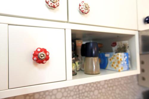 a white cabinet with a red button on it at Cute apartment in the Ljubljana old town in Ljubljana
