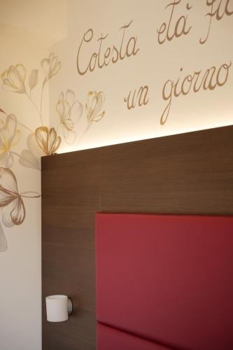 a room with a red door and a sign on the wall at Hotel Ristorante Da Tonino in Recanati