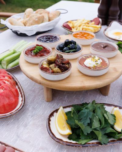 a table with plates of food on a table at Kekova Garden Village in Demre