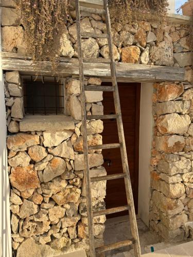 a ladder leaning up against a stone wall at Abate Filippo apartment in Nardò
