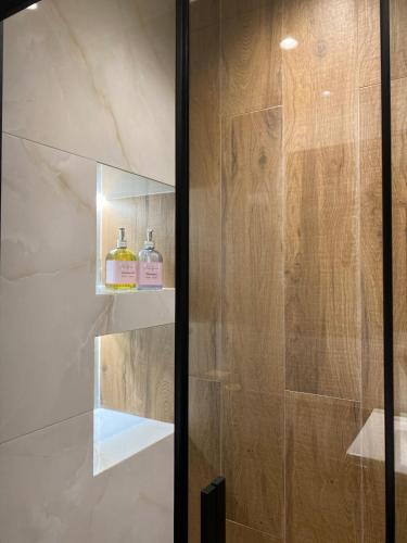 a bathroom with a shower with a glass door at Vitsas House in Athens