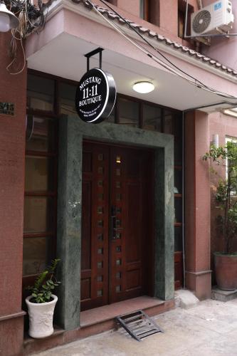 a door to a building with a sign above it at Mustang 11-11 Boutique Hotel Self Check In in Ho Chi Minh City