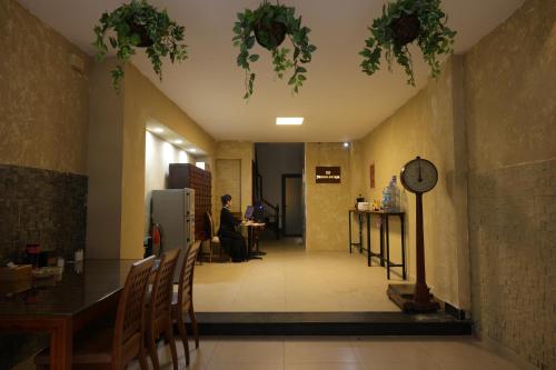 a dining room with a table and a clock on the ceiling at Mustang 11-11 Boutique Hotel Self Check In in Ho Chi Minh City