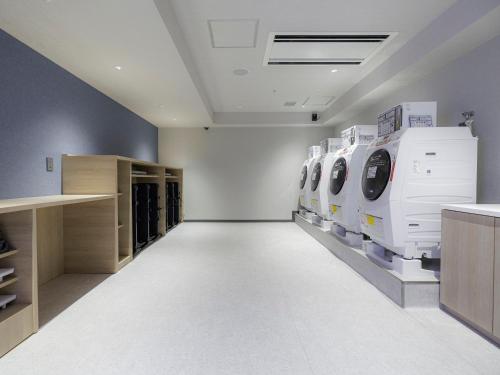 a laundry room with washing machines on display at JR Kyushu Station Hotel Kokura in Kitakyushu
