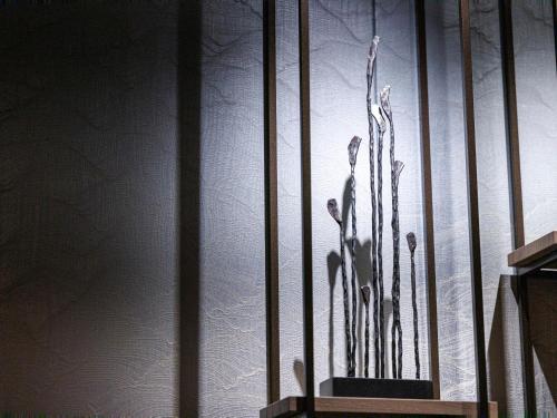 a glass display with a plant on a wall at JR Kyushu Station Hotel Kokura in Kitakyushu