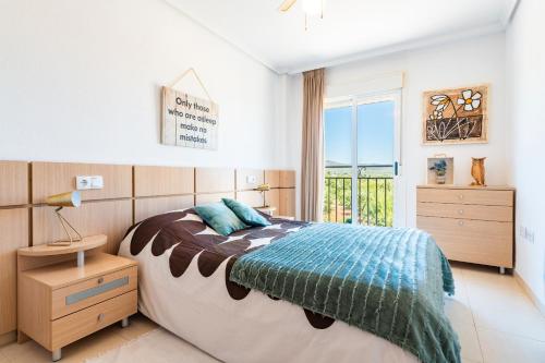 a bedroom with a large bed and a window at Duplex Torre La Sal Magic World in Cabanes