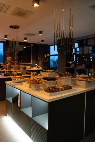 a kitchen with a buffet of food on a counter at Elexus Apartments Poiana Brasov in Poiana Brasov