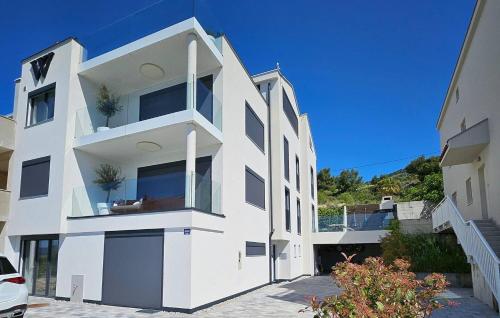 a large white building with windows on top of it at Double pleasure - two apartments with sea views and pool in Komarna