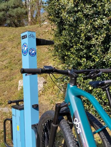 a bike is parked next to a sign at Ostello Casa Rossa in Laveno-Mombello