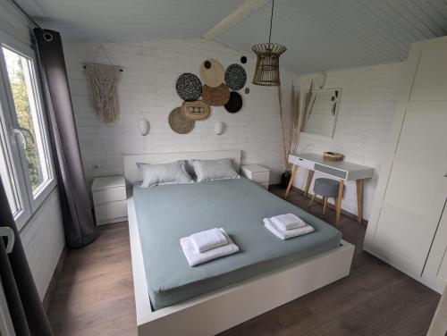 a bedroom with a bed and a table in it at Къщички Морски Светулки in Sinemorets