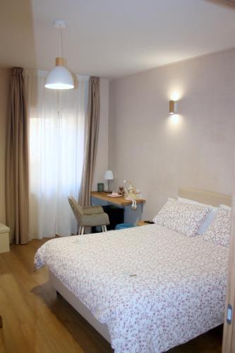 a bedroom with a bed and a desk with a desk at LA ROCCIA DI VICIDOMINI - Affittacamere in San Marco dei Cavoti
