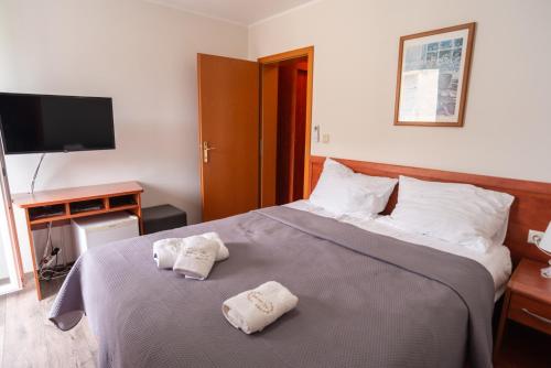 a bedroom with a bed with two towels on it at Villa Ana in Baška