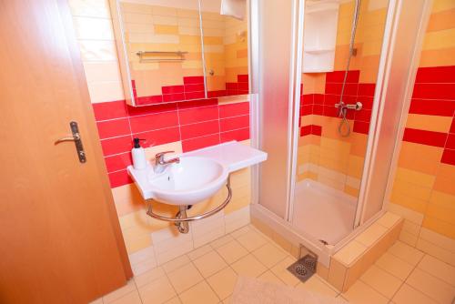 a bathroom with a sink and a shower at Villa Ana in Baška