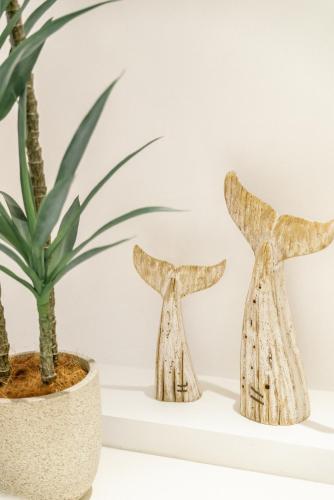 two wooden sculptures sitting next to a potted plant at Guan Erjie Boutique Hotel (Huimin Street of Xi'an Bell Tower ) in Xi'an