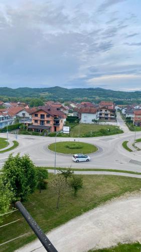 a street with a car driving down a road at Apartman Dina in Sanski most