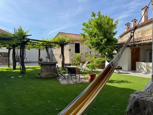 a slide in the yard of a house at Vila Kobdilj 1835 - Unique Stay in Karst Stone Villa in Štanjel