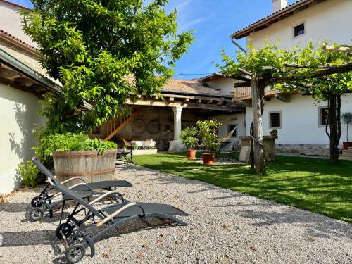 a group of chairs sitting in a yard at Vila Kobdilj 1835 - Unique Stay in Karst Stone Villa in Štanjel