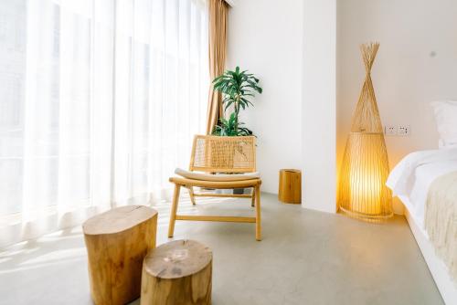 a bedroom with a chair and tree stump stools at Guan Erjie Boutique Hotel (Huimin Street of Xi'an Bell Tower ) in Xi'an