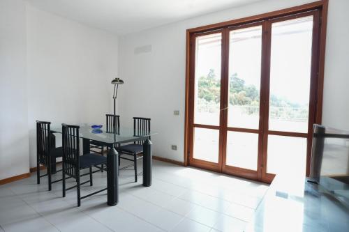 a dining room with a table and chairs and a window at Blue Horizon Apartment- 5 Terre in Monterosso al Mare