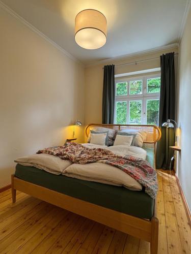 a bedroom with a large bed with a large window at Ferienapartment Janow in Spantekow