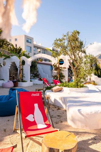 a red and white chair sitting on top of a beach at Stone Beach Residence - Adults Only Resort in Qeparo