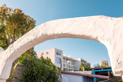 a stone archway over a building in a city at Stone Beach Residence - Adults Only Resort in Qeparo