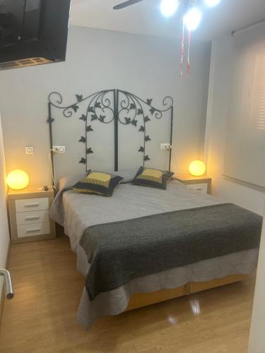 a bedroom with a large bed with a metal headboard at Apartment zona Naturista in Vera