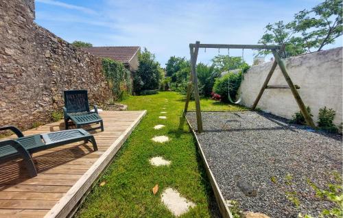 a wooden deck with a bench and a swing at 4 Bedroom Awesome Home In Paimboeuf in Saint-Paimboeuf