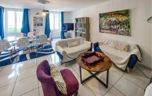 a living room with chairs and a table at 4 Bedroom Awesome Home In Paimboeuf in Saint-Paimboeuf