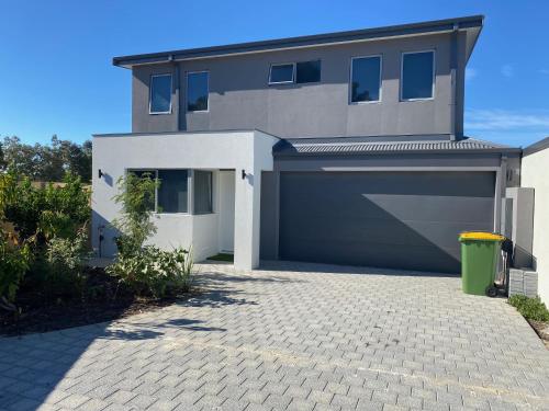 a house with a garage and a driveway at Canning Vale Family Accommodation in Perth