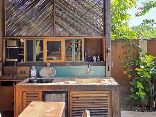 an outdoor kitchen with a counter and a sink at Apalagi Villas in Gili Air