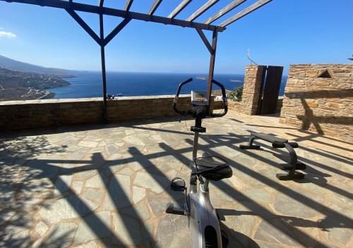 a scooter parked on a patio with a view of the ocean at andros prive suites in Kypri