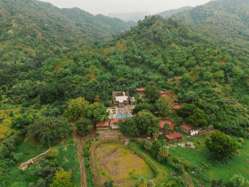 an aerial view of a house in the middle of a mountain at Aloof Jungle Lodge in Ghānerao